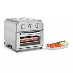 the toaster oven is next to a plate with food on it