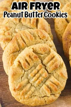 an air fryer peanut butter cookies on a cutting board with the words, air fryer peanut butter cookies