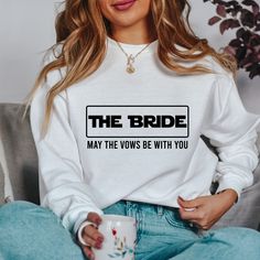 the bride may the vows be with you sweatshirt on woman sitting down holding coffee mug