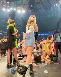 a group of people standing on top of a stage with lots of trash around them