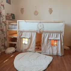 there is a bunk bed with curtains on the top and bottom, as well as a rug underneath it