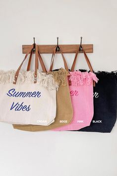 three bags hanging on a wall with the words summer vibes written on them in different colors