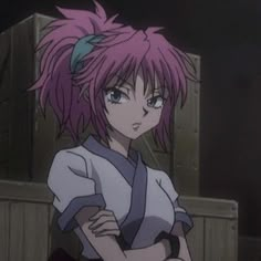 an anime character with pink hair and blue eyes standing in front of a box on the ground