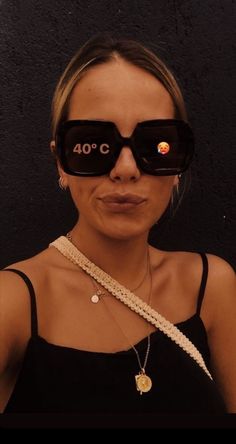 a woman wearing glasses with the words 40 o'clock on it, in front of her face