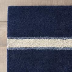 a blue and white rug on top of a wooden floor