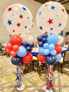 two red, white and blue balloons with streamers in the shape of stars on them