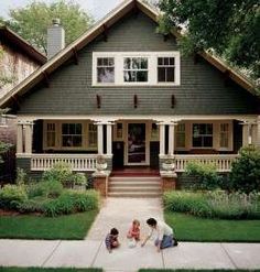 two children and an adult playing in front of a house