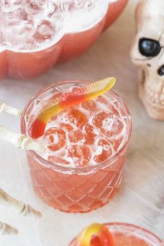 an orange drink in a glass with a toothpick sticking out of it