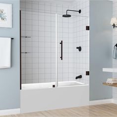 a bathroom with blue walls and white tile on the floor, along with a walk in shower