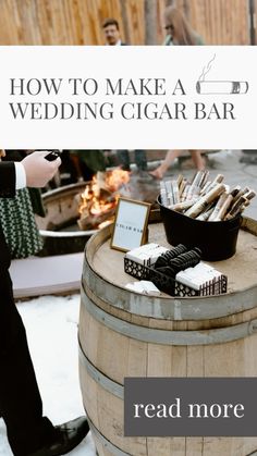 a man standing next to a barrel filled with cigars on top of snow covered ground