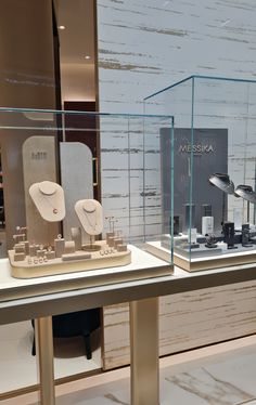 two display cases with different types of items on them in a store or showroom