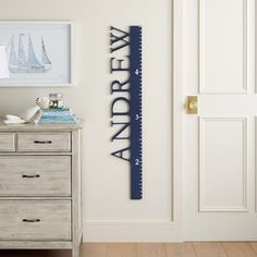 a room with a wooden dresser and wall hanging on the wall, along with a ruler