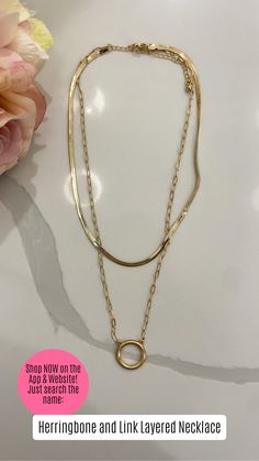 Add effortless elegance to your look with our Herringbone and Link Layered Necklace. This single piece features a sleek herringbone chain paired with a classic chain and bold metal hoop detail.  Finished in radiant gold, it’s perfect for layering or wearing solo to elevate any outfit, day or night.