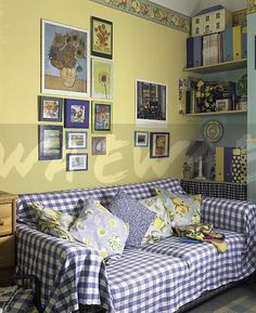 a living room filled with furniture and lots of pictures on the wall above it's couch