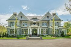 a large gray house with lots of windows