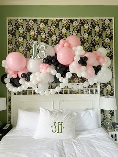 balloons are on the headboard of a bed