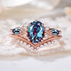 a ring with an oval blue topazte surrounded by three smaller round diamond accents