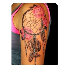 a woman's arm with pink roses and a dream catcher on it