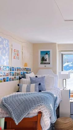 a bed room with a neatly made bed and pictures on the wall next to it