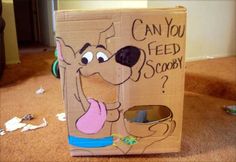 a cardboard box with an image of a dog on it that says can you feed scooby?