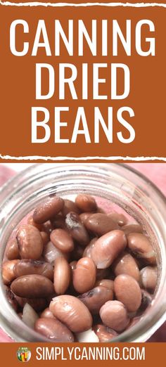 a glass jar filled with beans sitting on top of a table