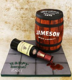 a birthday cake made to look like a barrel and a bottle of wine on top