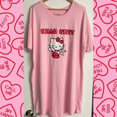 a pink shirt with an image of a hello kitty on it