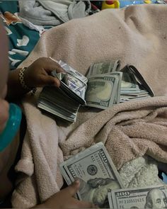 a pile of money sitting on top of a blanket