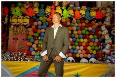 a man standing in front of a display of balloons