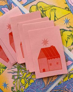 four cards with red houses on them