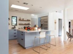 an open kitchen and dining room area with zebra print rugs on the hardwood flooring