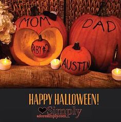 pumpkins and candles with the words happy halloween written on them are sitting next to each other