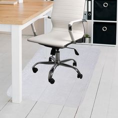 a white office chair sitting on top of a hard wood floor next to a desk