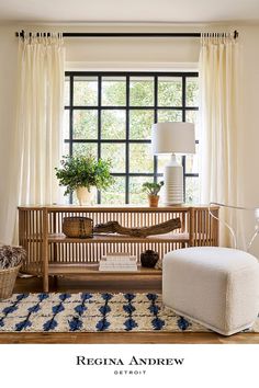 a living room filled with furniture and a lamp next to a window covered in curtains