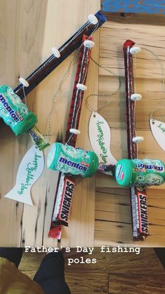 two toothbrushes and some candy on a wooden table with the caption father's day fishing poles