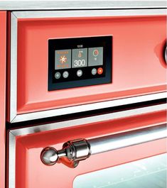 the oven is red and has an electronic display on it's front door,