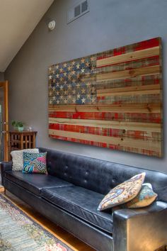 a living room filled with furniture and an american flag painting on the wall