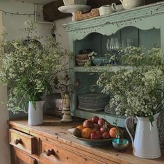 an old dresser with flowers and fruit on it