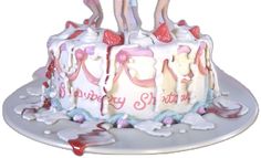 a birthday cake decorated with pink and white frosting, two girls on top of the cake