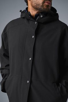 Stay dry without compromising style in this coat. It's stacked with functional features like a tall collar, a hood with bungees, zippered side pockets, and a secure zipper-and-snap front. Plus, it's made from soft, lightweight, 100 percent waterproof ripstop with a relaxed fit to accommodate movement. Cool on the streets? Yes. Suitable for stormy days? Also yes. Functional Outerwear With Detachable Hood For Work, Alo Yoga Hooded Outerwear With Drawstring, Techwear Outerwear With Detachable Hood For Work, Alo Yoga Fall Outerwear With Drawstring Hood, Alo Yoga Drawstring Hood Outerwear For Fall, Alo Yoga Outerwear With Drawstring Hood For Fall, Urban Outerwear With Detachable Hood For Work, Casual Black Alo Yoga Outerwear, Black Winter Commuting Outerwear