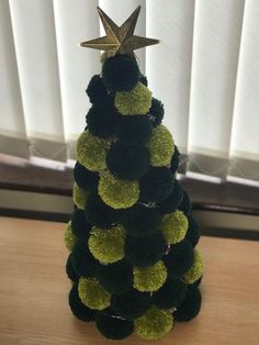 a small christmas tree made out of pom - poms