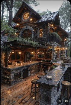 an outdoor kitchen and bar with lights on the outside