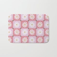 a pink and white flower pattern bath mat