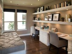 a bedroom with a bed, desk and shelves filled with pictures on the wall above it