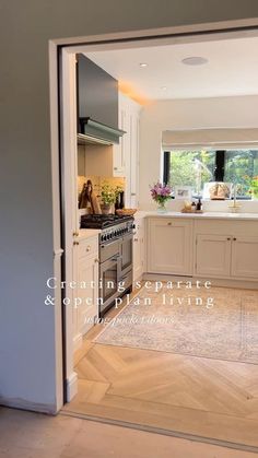 an open door leading to a kitchen with white cabinets