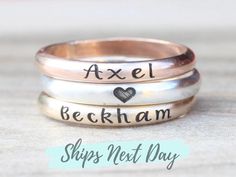 Simple name stacking rings. Made with .925 sterling silver, 14K gold filled, or 14K rose gold filled. Listing is for one ring Symbols available for engraving: 🖤   o   *   ∞   🐾   ↢   ↣   ♫ The band is 2.59mm wide. Please message me if you would like a different font. These rings are made of high quality materials. The colors will not chip off or fade and can be worn in water. This ring is made to order in your size. If you don't see your size available please feel free to message me. All order Handmade Sterling Silver Stackable Rings In Rose Gold, Handmade Rose Gold Sterling Silver Stackable Rings, Custom Name Stackable Rose Gold Promise Rings, Custom Name Rose Gold Jewelry For Promise Ring, Personalized Rose Gold Stackable Promise Rings, Personalized Rose Gold Stackable Rings With Round Band, Rose Gold Custom Name Jewelry For Promise, Custom Name Rose Gold Promise Ring, Personalized Rose Gold Stackable Rings