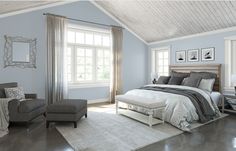 a large bedroom with blue walls and white trim on the ceiling, along with two chairs