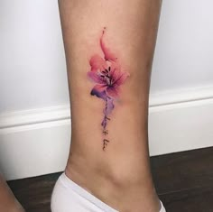 a watercolor style flower tattoo on the ankle