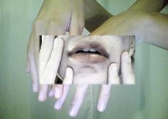 a woman's hands with white nails holding up an image of her face