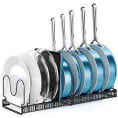 an assortment of kitchen utensils and pans in a rack on a white background